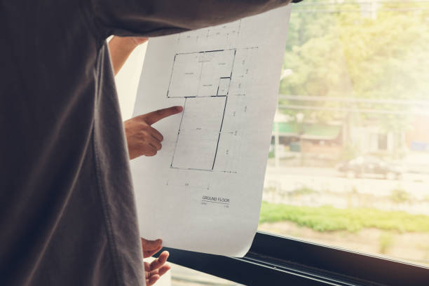 istock Engineer and Architect concept, Engineer Architects office team working and discussing house plan with blueprints and house model, Vintage Effect 840719684