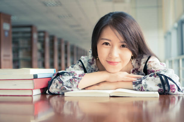 istock Pretty girl on the book in the library 840726262