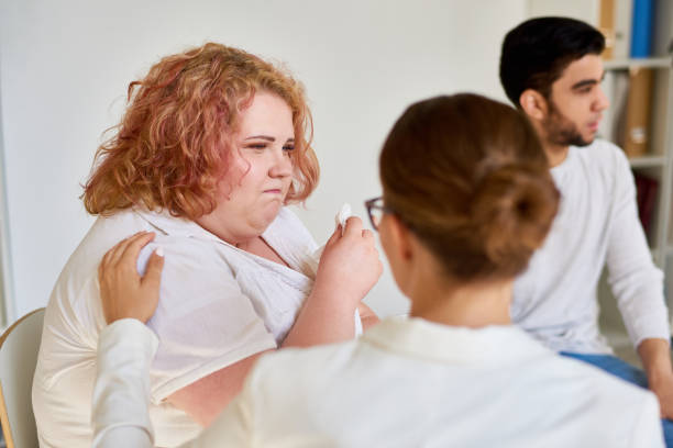 istock Obese Young Woman Crying in Support Group Session 840729646