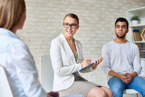 istock Beautiful Female Psychologist Leading Group Therapy Session 840729720