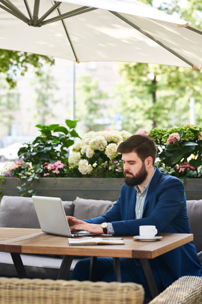 istock Modern Businessman Working with Laptop Outdoors 840729768