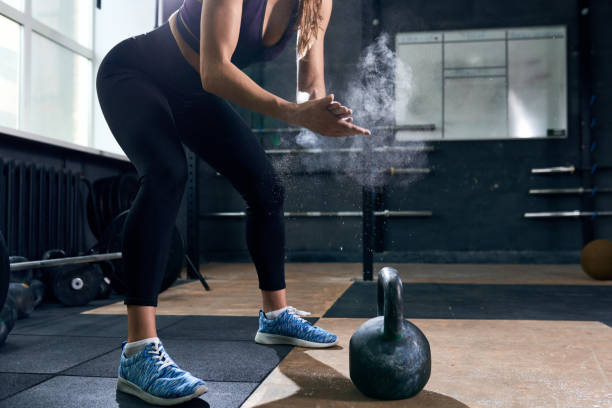 istock Strong Woman Lifting Kettlebells in  Gym 840730046