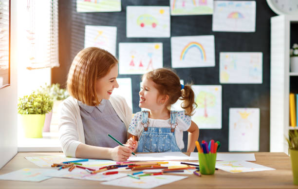 istock mother and child daughter draws in creativity in kindergarten 840730376
