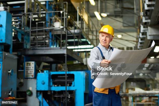Senior Construction Worker Holding Floor Plans Stock Photo - Download Image Now - 70-79 Years, Active Seniors, Adult