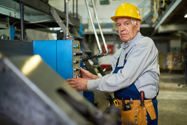 istock Senior Worker Operating Machine Units at Factory 840732660