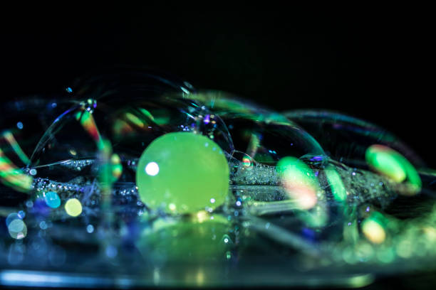 istock Glass with water and soap bubbles with colored light 840733320