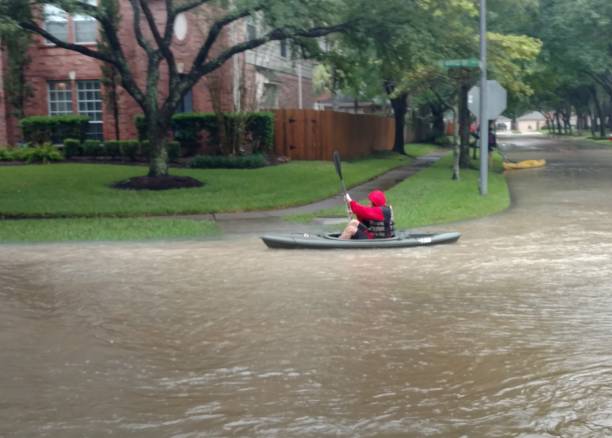 A man paddles his kayak in the flood on the suburban streets of Clear Lake, Houston, Texas, from the rainfall from Hurricane Harvey.