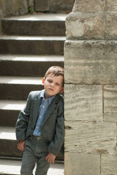istock Beautiful little boy in a costume leaning on an ancient wall 840749248