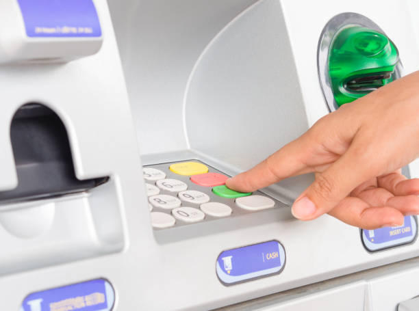 istock Close-up of woman's hand inserting debit card into an ATM machine. 840751528
