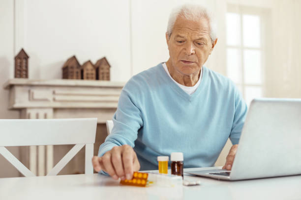 istock Nice elderly man sitting in front of the laptop 840757448