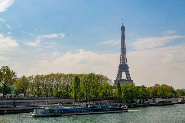 istock Paris Eiffel Tower against Cloudy Blue Sky with Tourists Boat 840759442