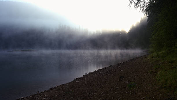 istock Fog over the mountain lake 840767546