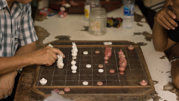istock Man are playing old a chess board on wooden table. 840767730