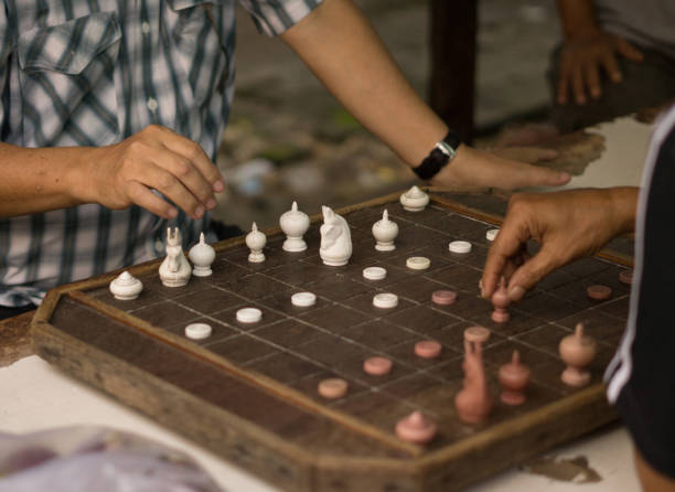 istock Man are playing old a chess board on wooden table. 840769812