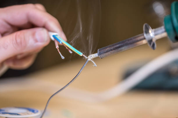 istock Male worker works with solder wire 840774062
