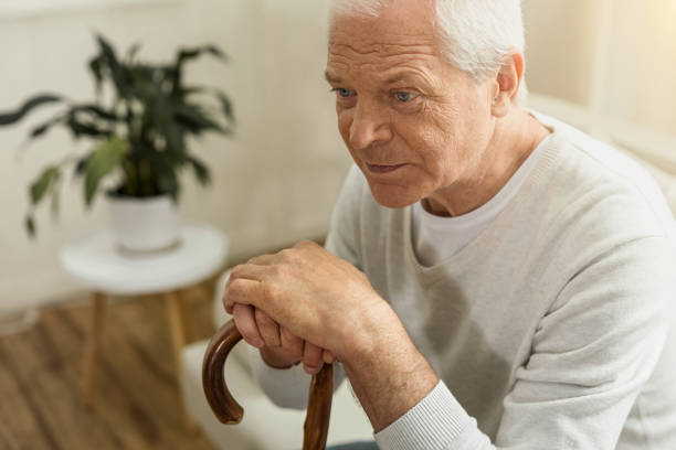 istock Cheerless elderly man sitting in his house 840774688