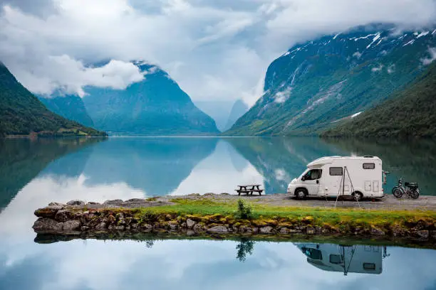 Photo of Family vacation travel RV, holiday trip in motorhome, Caravan car Vacation. Beautiful Nature Norway natural landscape.