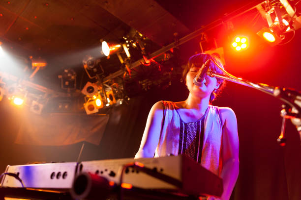 istock Woman Playing Electronic Keyboard At Live Event 840782576