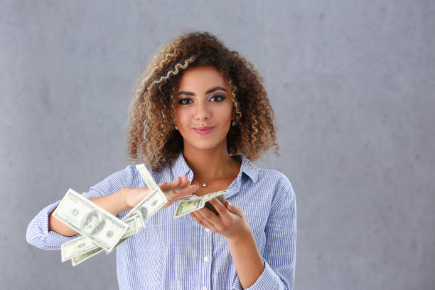 Beautiful black woman portrait. Beautiful black woman portrait. Scattering money notes dollars in fashion vows style curly hair with white locks eye view of the camera prosperity stock pictures, royalty-free photos & images