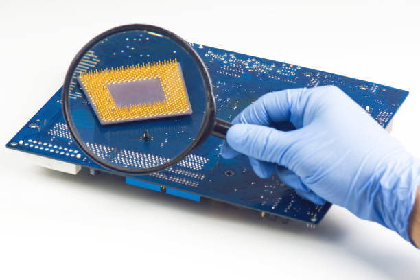 istock Holding Magnifying Glass In Front Of Processor 840783860
