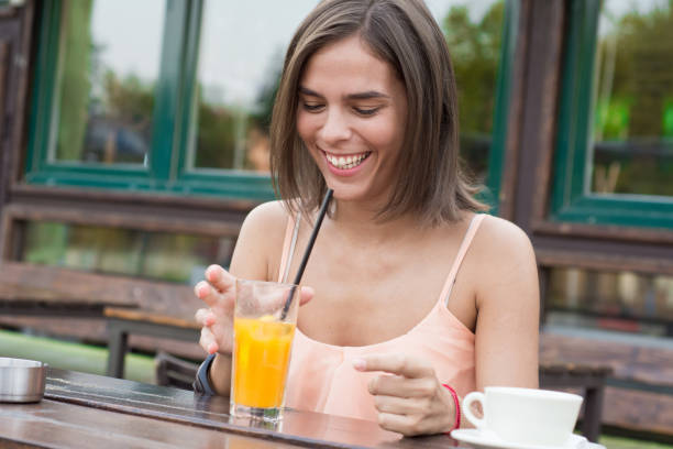 istock smiling young women with coffee cups at cafe 840783980