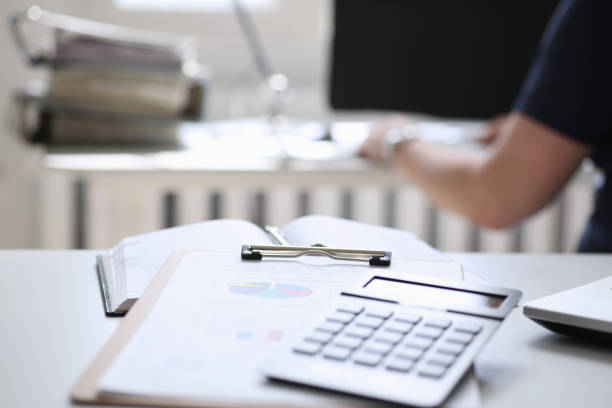 istock Black calculator and financial statistics on clipboard pad 840788978