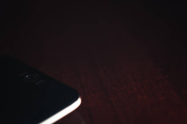 istock Smart Phone on a Wooden Table Surface Background 840789138