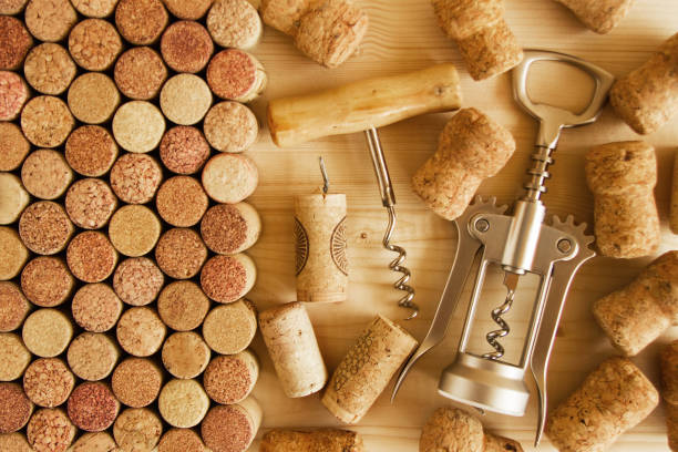 istock Wine corks and two corkscrews on the wooden background, top view. 840789616