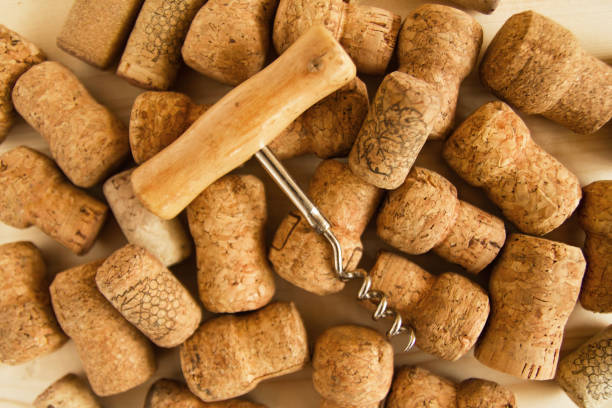 istock Wine corks and corkscrew on the wooden background, top view. 840789644