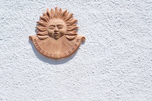 istock Sundial in clay pottery representing a sun on an empty white wall 840793466