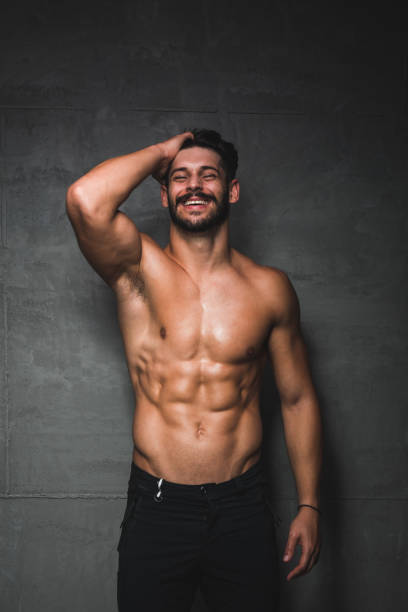 Smart fitness man smiling to the camera, white background, studio shot, sport activity