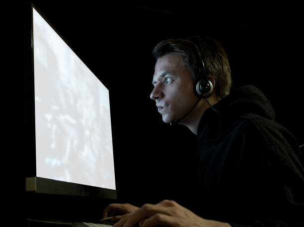istock Young gamer playing in dark room 840795196