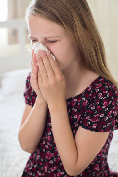 istock Girl Suffering With Cold Sneezing Into Tissue 840795924
