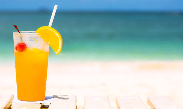 istock orange juice drink on the beach table, summer fresh cool water for relaxation, copy space. 840803842
