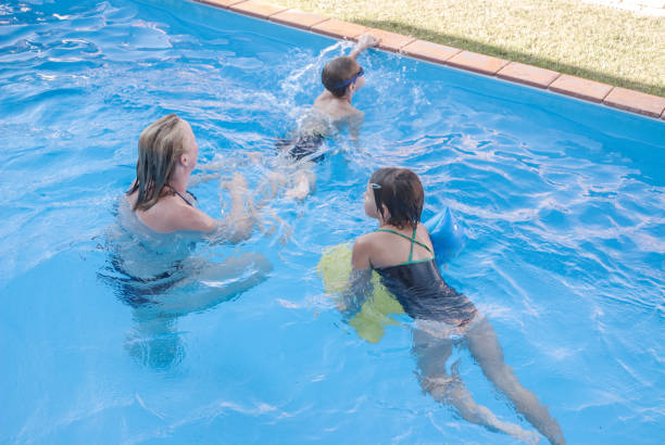 istock Mother and Two Children in the Pool 840806664