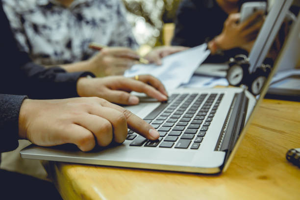 istock Businessman's fingers hit the return button on laptop keyboard at the office. 840810480