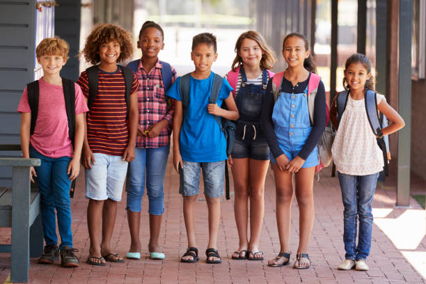 istock Portrait of kids standing in elementary school hallway 840813434