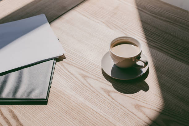 istock cup of coffee and notebooks on table 840813736