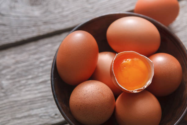istock Fresh brown eggs in bowl on wood background 840815556