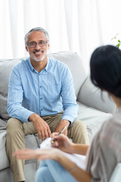 istock Female doctor writing on clipboard while consulting a man 840815944