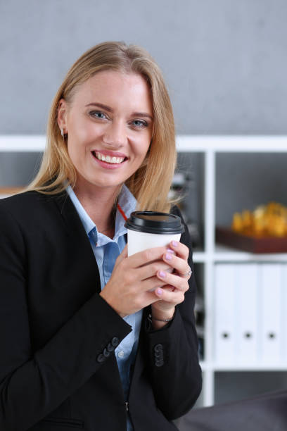istock Smiling business woman drinking coffee from a paper cup 840815970