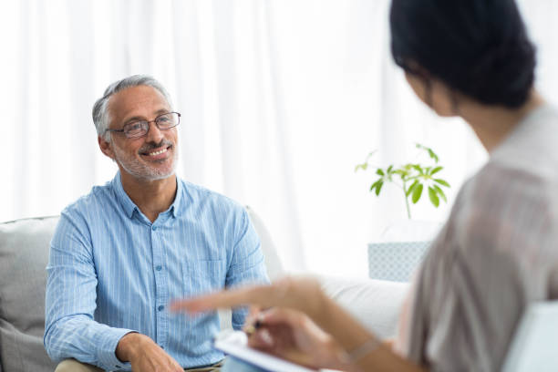 istock Female doctor writing on clipboard while consulting a man 840815998