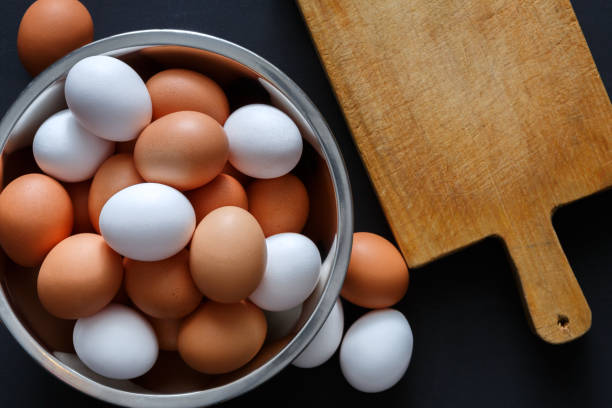 istock Fresh brown eggs in bowl on wood background 840816160