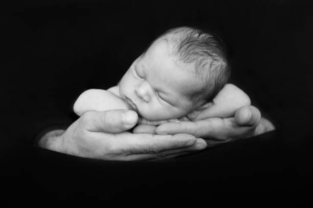 istock Beautiful baby boy, sleeping peacefully in fathers hands, infant sleeping 840821680