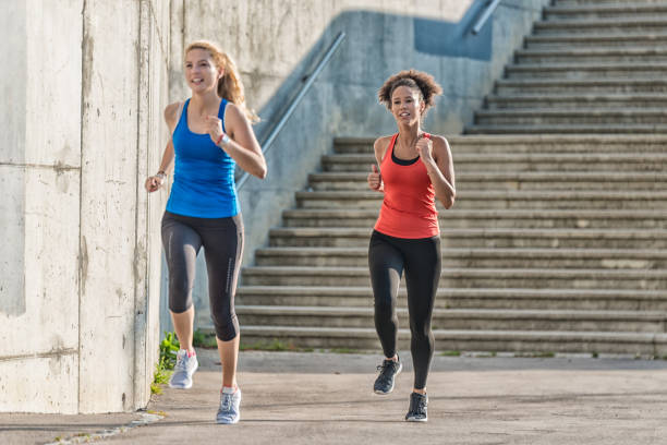 istock Two female athletes running together 840821862