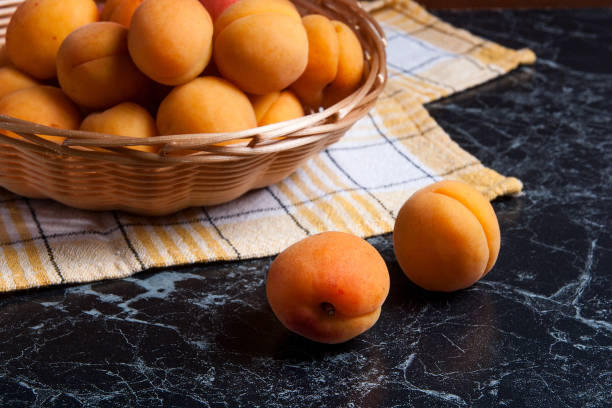 istock Group of harvested apricots in basket. 840826158