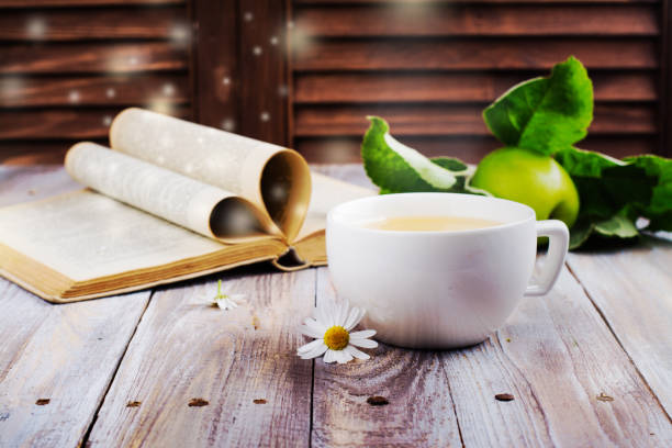 Cup of herbal tea and old book