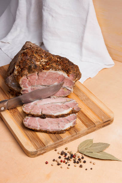 istock Sliced baked pork with herbs and spice on wooden board. 840827182