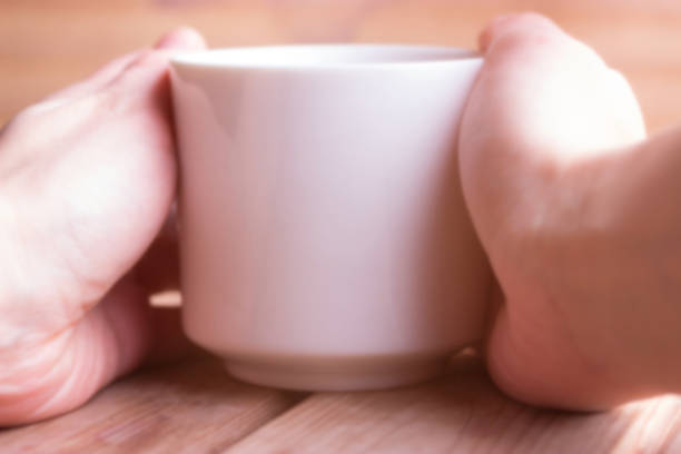 istock cup of hot tea or coffee in hands 840827206