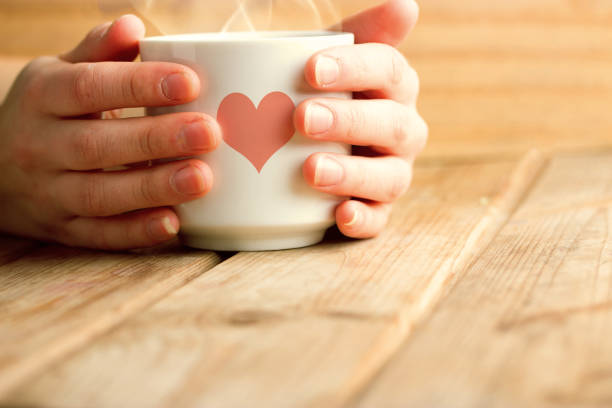 istock cup of hot tea or coffee in hands 840827242
